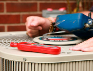 Close up of someone inspecting an air conditioning system